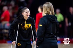 Iowa Hawkeye guard Taylor McCabe talking with an assistant while out with injury before taking on the Nebraska Cornhuskersduring a college basketball game on Monday, Feb. 16, 2026, in Lincoln, Nebraska. Photo by John S. Peterson.