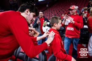 Nebraska Cornhusker forward Berke Büyüktuncel (9) signs autographs after the game against the Northwestern Wildcats during a college basketball game on Saturday, Feb. 14, 2026, in Lincoln, Nebraska. Photo by John S. Peterson.