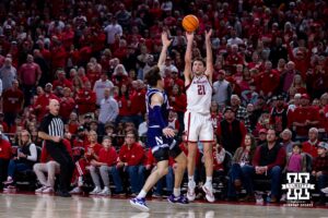 Nebraska Cornhusker forward Pryce Sandfort (21) makes a three point basket against Northwestern Wildcat guard Angelo Ciaravino (44) in the second half during a college basketball game on Saturday, Feb. 14, 2026, in Lincoln, Nebraska. Photo by John S. Peterson.