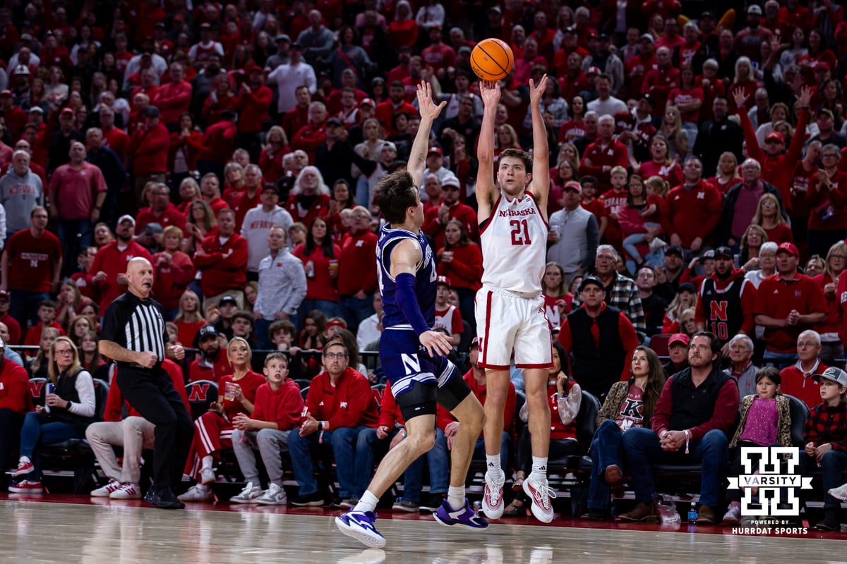 Nebraska MBB v Northwestern Feb 14, 2026 | Hail Varsity Nebraska Cornhusker forward Pryce Sandfort (21) makes a three point basket against Northwestern Wildcat guard Angelo Ciaravino (44) in the second half during a college basketball game on Saturday, Feb. 14, 2026, in Lincoln, Nebraska. Photo by John S. Peterson.