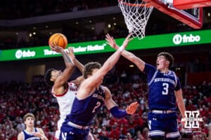 Nebraska Cornhusker guard Jamarques Lawrence (10) makes a lay up against Northwestern Wildcat forward Nick Martinelli (2) and guard Jake West (3) in the second half during a college basketball game on Saturday, Feb. 14, 2026, in Lincoln, Nebraska. Photo by John S. Peterson.