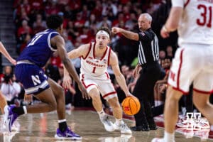 Nebraska Cornhusker guard Sam Hoiberg (1) dribbles the ball against Northwestern Wildcat guard Jordan Clayton (11) in the first half during a college basketball game on Saturday, Feb. 14, 2026, in Lincoln, Nebraska. Photo by John S. Peterson.