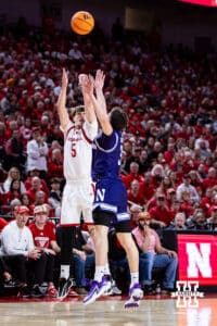 Nebraska Cornhusker forward Braden Frager (5) makes a three point basket against Northwestern Wildcat guard Jake West (3) in the first half during a college basketball game on Saturday, Feb. 14, 2026, in Lincoln, Nebraska. Photo by John S. Peterson.