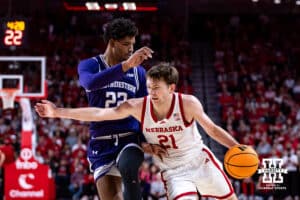 Nebraska Cornhusker forward Pryce Sandfort (21) drives to the basket against Northwestern Wildcat forward Arrinten Page (22) in the first half during a college basketball game on Saturday, Feb. 14, 2026, in Lincoln, Nebraska. Photo by John S. Peterson.