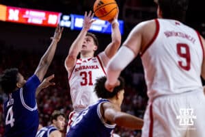 Nebraska Cornhusker guard Cale Jacobsen (31) makes a lay up against Northwestern Wildcat guard Jayden Reid (4) in the first half during a college basketball game on Saturday, Feb. 14, 2026, in Lincoln, Nebraska. Photo by John S. Peterson.