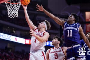Nebraska Cornhusker guard Sam Hoiberg (1) makes a lay up against Northwestern Wildcat guard Jordan Clayton (11) int he first half during a college basketball game on Saturday, Feb. 14, 2026, in Lincoln, Nebraska. Photo by John S. Peterson.
