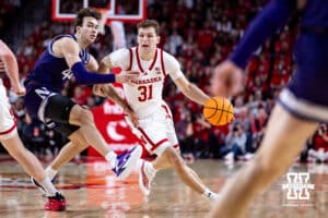 Nebraska Cornhusker guard Cale Jacobsen (31) dribbles the ball against Northwestern Wildcat guard Angelo Ciaravino (44) in the first half during a college basketball game on Saturday, Feb. 14, 2026, in Lincoln, Nebraska. Photo by John S. Peterson.