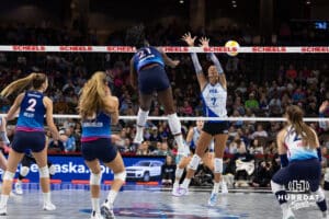 Omaha Supernovas Toyosi Onabanjo (21) spikes the ball past Dallas Pulse Layne Van Buskirk (7) in the first set during a professional volleyball match on Thursday, Feb. 12, 2026, in Omaha, Nebraska. Photo by John S. Peterson.