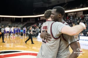 Omaha Mavericks Tony Osburn (32) and Valentino Simon (21) hug after a college basketball game against St. Thomas on Feb 12, 2026, in Omaha, Nebraska. Photo by Brandon Tiedemann