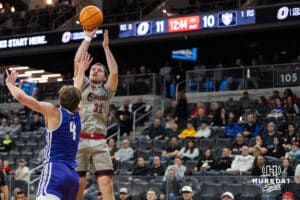 Omaha Maverick Tony Osburn (32) shoots a shot over a defender during a college basketball game against St. Thomas on Feb 12, 2026, in Omaha, Nebraska. Photo by Brandon Tiedemann