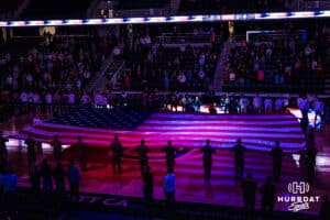 The USA flag is held before a college basketball game against St. Thomas on Feb 12, 2026, in Omaha, Nebraska. Photo by Brandon Tiedemann