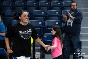 Creighton Bluejay Grace Boffeli (42) high fives a young fan before a college basketball game against Georgetown on Feb 4, 2026, in Omaha, Nebraska. Photo by Brandon Tiedemann