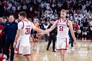 and forward Rienk Mast (51) give each other five after the loss to the Illinois Fighting Illini during a college basketball game on Sunday, Feb. 1, 2026, in Lincoln, Nebraska. Photo by John S. Peterson.