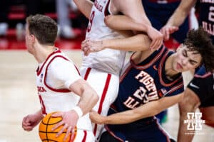 Illinois Fighting Illini guard Keaton Wagler (23) is blocked out by Nebraska Cornhusker forward Berke Büyüktuncel (9) as guard Cale Jacobsen (31) dribbles past during a college basketball game on Sunday, Feb. 1, 2026, in Lincoln, Nebraska. Photo by John S. Peterson.