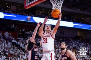 Nebraska Cornhusker guard Cale Jacobsen (31) makes a lay up against Illinois Fighting Illini forward Jake Davis (15) in the first half during a college basketball game on Sunday, Feb. 1, 2026, in Lincoln, Nebraska. Photo by John S. Peterson.