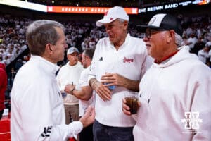 Retired NBA star Kevin McHale (center) talks to Nebraska govenor Jim Pillen before Nebraska takes on Illinois during a college basketball game on Sunday, Feb. 1, 2026, in Lincoln, Nebraska. Photo by John S. Peterson.
