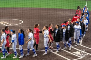 The Nebraska Cornhuskers and Creighton Bluejays high five after a college softball game on March 31, 2026, in Omaha, Nebraska. Photo by Brandon Tiedemann