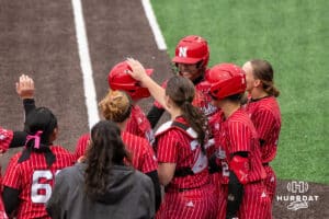 Nebraska Cornhusker Kacie Hoffmann (14) celebrates her home-run with her teammates during a college softball game against Creighton on March 31, 2026, in Omaha, Nebraska. Photo by Brandon Tiedemann