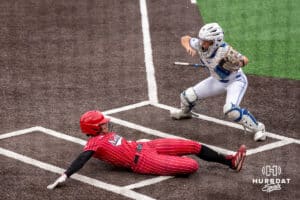 Nebraska Cornhusker Samantha Bland (29) slides into home during a college softball game against Creighton on March 31, 2026, in Omaha, Nebraska. Photo by Brandon Tiedemann