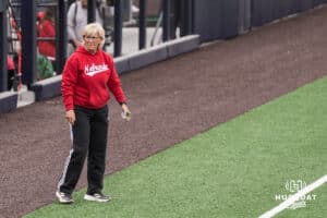 Nebraska Cornhusker head coach Rhonda Revelle stands on the third base line during a college softball game against Creighton on March 31, 2026, in Omaha, Nebraska. Photo by Brandon Tiedemann