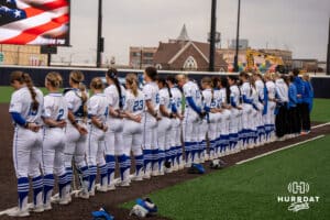 The Creighton Bluejays stand for the anthem during a college softball game against Nebraska on March 31, 2026, in Omaha, Nebraska. Photo by Brandon Tiedemann
