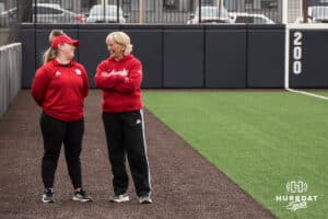 Nebraska Cornhusker head coach Rhonda Revelle chats with a coach before a college softball game against Creighton on March 31, 2026, in Omaha, Nebraska. Photo by Brandon Tiedemann