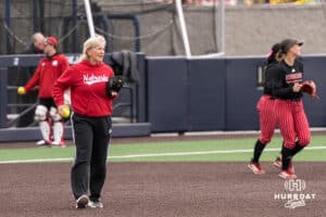 Nebraska Cornhusker head coach Rhonda Revelle helps the team warm up before a college softball game against Creighton on March 31, 2026, in Omaha, Nebraska. Photo by Brandon Tiedemann