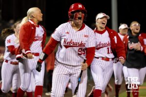 Nebraska pitcher Alexis Jensen (99) celebrates a home run as batter Hannah Camenzind (9) rounds the bases during a college softball game against UCLA, Mar. 27, 2026, Lincoln, Nebraska. Photo by Braden Cochran.