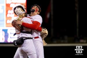 Nebraska Huskers Alexis Jensen (99) and catcher Jesse Farrell (25) celebrate after a strikeout during a college softball game against UCLA, Mar. 27, 2026, Lincoln, Nebraska. Photo by Braden Cochran.