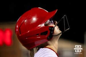 A Nebraska batter mentally prepares in the on-deck circle before her next attempt at bat during a college softball game against UCLA, Mar. 27, 2026, Lincoln, Nebraska. Photo by Braden Cochran.