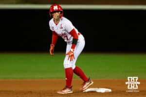 Nebraska baserunner Ava Kuszak (7) watches the pitcher as she’s ready to break for third base during a college softball game against UCLA, Mar. 27, 2026, Lincoln, Nebraska. Photo by Braden Cochran.