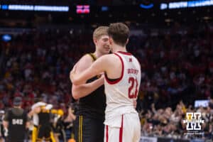 Nebraska Cornhusker forward Pryce Sandfort (21) talks to Iowa Hawkeye forward Cooper Koch (8) after the loss during the Sweet Sixteen of the NCAA Men’s Basketball Championship on Thursday, March 26, 2026, in Houston. Photo by John S. Peterson.