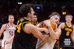 Nebraska Cornhusker guard Sam Hoiberg (1) rips the ball away form Iowa Hawkeye guard Tate Sage (24) in the second half during the Sweet Sixteen of the NCAA Men’s Basketball Championship on Thursday, March 26, 2026, in Houston. Photo by John S. Peterson.