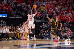 Nebraska Cornhusker guard Jamarques Lawrence (10) makes a three point basket over Iowa Hawkeye guard Kael Combs (11) in the first half during the Sweet Sixteen of the NCAA Men’s Basketball Championship on Thursday, March 26, 2026, in Houston. Photo by John S. Peterson.
