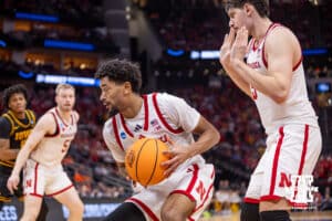 Nebraska Cornhusker guard Jamarques Lawrence (10) scoops up the ball against the Iowa Hawkeyes in the first half during the Sweet Sixteen of the NCAA Men’s Basketball Championship on Thursday, March 26, 2026, in Houston. Photo by John S. Peterson.