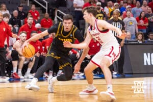 Nebraska Cornhusker forward Pryce Sandfort (21) guards Iowa Hawkeye forward Alvaro Folgueiras (7) in the first half during the Sweet Sixteen of the NCAA Men’s Basketball Championship on Thursday, March 26, 2026, in Houston. Photo by John S. Peterson.