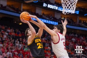 Nebraska Cornhusker forward Berke Büyüktuncel (9) blocks a shot by Iowa Hawkeye guard Tate Sage (24) in the first half during the Sweet Sixteen of the NCAA Men’s Basketball Championship on Thursday, March 26, 2026, in Houston. Photo by John S. Peterson.
