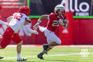 Nebraska Cornhusker running back Isaiah Mozee (22) runs with the ball against linebacker Derek Wacker (42) during the Spring Game on Saturday, March 28, 2026, in Lincoln. Photo by John S. Peterson.