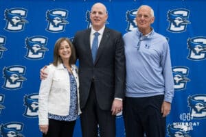Creighton Bluejay head coach in waiting Alan Huss smiles with his parents during his introductory press conference on March 25, 2026, in Omaha, Nebraska. Photo by Brandon Tiedemann