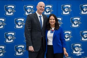 Creighton Bluejay head coach in waiting Alan Huss stands with his wife during his introductory press conference on March 25, 2026, in Omaha, Nebraska. Photo by Brandon Tiedemann