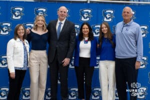 Creighton Bluejay head coach in waiting Alan Huss poses with his family and parents during his introductory press conference on March 25, 2026, in Omaha, Nebraska. Photo by Brandon Tiedemann