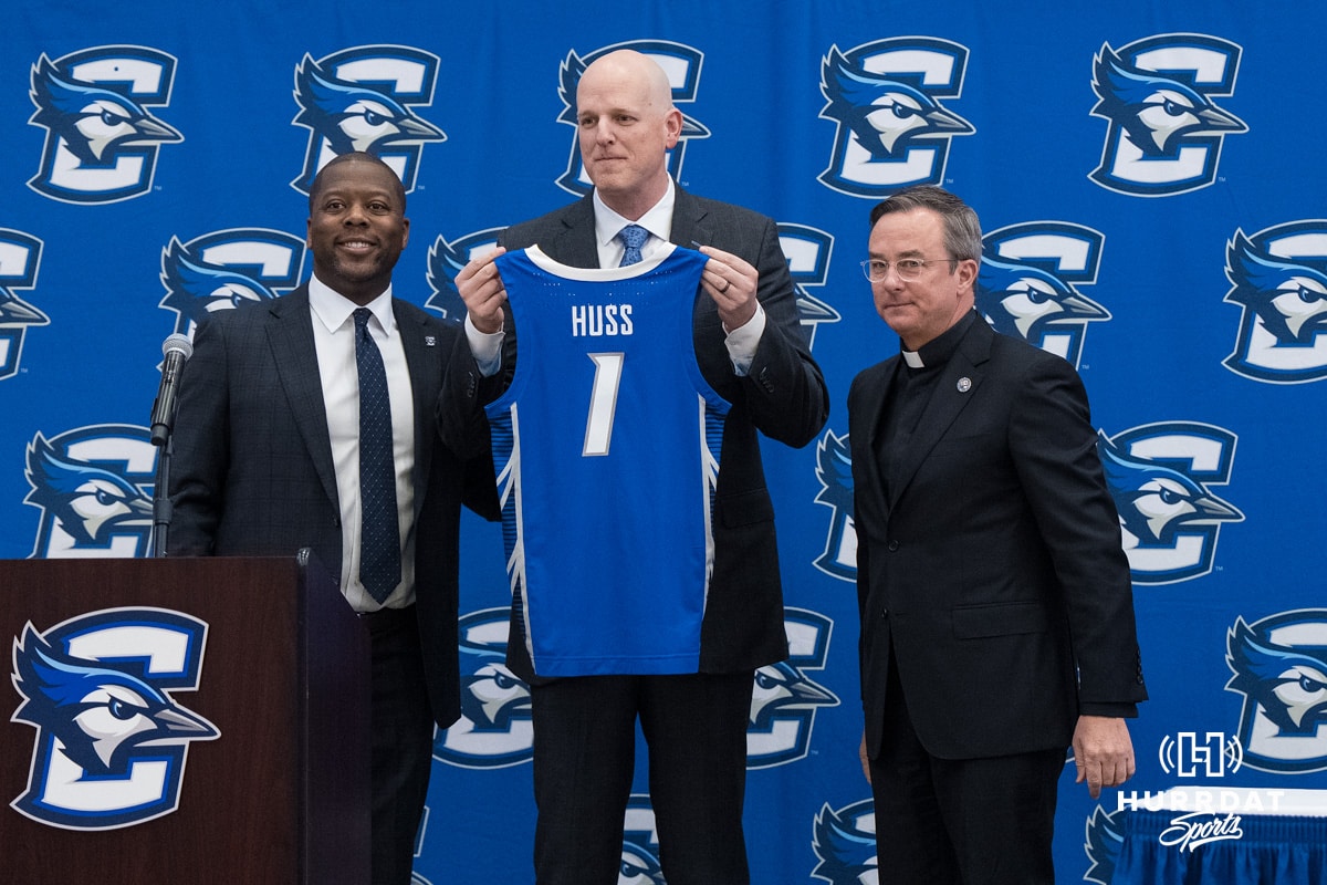 Creighton Bluejay head coach in waiting Alan Huss holds up his jersey during his introductory press conference on March 25, 2026, in Omaha, Nebraska. Photo by Brandon Tiedemann