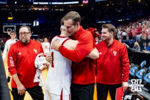 Nebraska Cornhusker guard Sam Hoiberg (1) gives his father Fred Hoiberg a hug after the win over the Troy Trojans during the first round of the NCAA Men’s Basketball Championship on Thursday, March 19, 2026, in Oklahoma City. Photo by John S. Peterson.