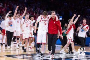 Nebraska Cornhusker head coach Fred Hoiberg and Braden Frager walking together after the win over the Troy Trojans during the first round of the NCAA Men’s Basketball Championship on Thursday, March 19, 2026, in Oklahoma City. Photo by John S. Peterson.