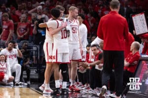 Nebraska Cornhusker Pryce Sandfort (21) and Jamarques Lawrence hug after taking the bench late in the second half against the Troy Trojans during the first round of the NCAA Men’s Basketball Championship on Thursday, March 19, 2026, in Oklahoma City. Photo by John S. Peterson.