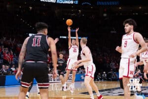 Nebraska Cornhusker forward Pryce Sandfort (21) makes a three point shot against the Troy Trojans during the first round of the NCAA Men’s Basketball Championship on Thursday, March 19, 2026, in Oklahoma City. Photo by John S. Peterson.