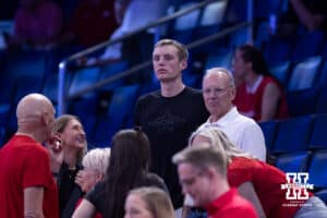 Nebraska Cornhusker forward Pryce Sandfort's brother in the blasck t-shirst Payton watches warm ups before taking on the Troy Trojans during the first round of the NCAA Men’s Basketball Championship on Thursday, March 19, 2026, in Oklahoma City. Photo by John S. Peterson.