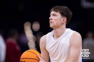 Nebraska Cornhusker forward Pryce Sandfort (21) takes a three-point basket warming up for Troy Trojans during the first round of the NCAA Men’s Basketball Championship on Thursday, March 19, 2026, in Oklahoma City. Photo by John S. Peterson.