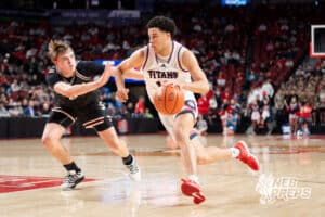Norris's Chris Garner Jr. (10) drives guarded by Scottsbluff's Caleb Burda (0) during a Boys State Championship Semifinal Round basketball game Friday, March 13, 2026, in Lincoln, Nebraska. Photo by Jackson D. Luethje.