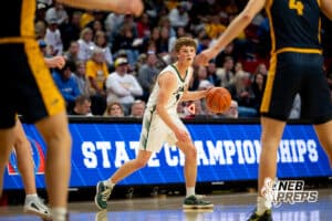 Howells-Dodge point guard Dane Meyer (1) is stalked by two Elm Creek defenders from just beyond the arc during a boys state semifinal basketball game, Mar. 13, 2026, Lincoln, Nebraska. Photo by Braden Cochran.